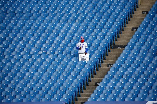 A solitary Buffalo Bills fan watches as his team warms up before an NFL wild-card playoff football game against the Indianapolis Colts, in Orchard Park in Buffalo.